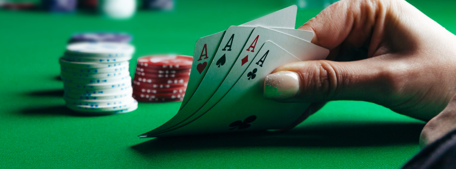 female hand holding poker cards and chips